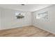 Spacious bedroom with light wood floors and two windows at 3054 Markridge Rd, Sarasota, FL 34231