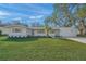 White house with wood accents, landscaped lawn, and driveway at 3054 Markridge Rd, Sarasota, FL 34231