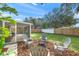 Inviting fire pit area with gray chairs and wood chips at 3054 Markridge Rd, Sarasota, FL 34231