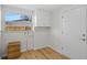 Laundry room with built-in cabinets and wood flooring at 3054 Markridge Rd, Sarasota, FL 34231