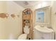 Clean bathroom with a vanity, toilet, and wicker shelving at 318 Barlow Ave # 71, Sarasota, FL 34232