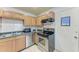 Kitchen with stainless steel appliances and wood cabinets at 318 Barlow Ave # 71, Sarasota, FL 34232