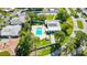 Community pool and surrounding buildings from above at 3530 Tree Line Dr # 4, Sarasota, FL 34231