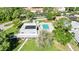 Aerial view of community pool, clubhouse, and surrounding landscape at 3530 Tree Line Dr # 4, Sarasota, FL 34231