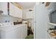 Laundry room with washer, dryer, and ample storage space at 3530 Tree Line Dr # 4, Sarasota, FL 34231