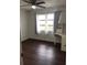 Well-lit bedroom with wood-look floors and ceiling fan at 406 Barlow Ave # 65, Sarasota, FL 34232