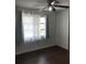 Bright bedroom with dark wood floors and window at 406 Barlow Ave # 65, Sarasota, FL 34232