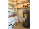 Small pantry with shelves and water heater at 406 Barlow Ave # 65, Sarasota, FL 34232