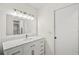 Modern bathroom with white vanity, quartz countertop and large mirror at 4410 Little John Trl, Sarasota, FL 34232