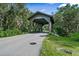 Picturesque covered bridge entrance to the community at 4410 Little John Trl, Sarasota, FL 34232