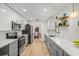 Modern kitchen with gray cabinets, white countertops, and stainless steel appliances at 4410 Little John Trl, Sarasota, FL 34232