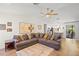 Living room with sectional sofa, hardwood floors, and view of kitchen at 4410 Little John Trl, Sarasota, FL 34232