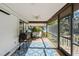 Relaxing screened porch with ceiling fan and outdoor grill at 4410 Little John Trl, Sarasota, FL 34232