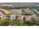 Aerial view of community with lake, mature landscaping, and numerous houses at 4677 Sweetmeadow Cir, Sarasota, FL 34238