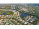 Aerial view of a large community featuring houses, lakes, and lush greenery at 4677 Sweetmeadow Cir, Sarasota, FL 34238