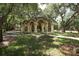 Elegant pergola pathway with arched stone details at 4677 Sweetmeadow Cir, Sarasota, FL 34238