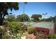 Well-maintained tennis courts with surrounding landscaping at 4677 Sweetmeadow Cir, Sarasota, FL 34238