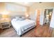 Main bedroom with king bed, ensuite bathroom access, and wood floors at 5169 Oxford Dr, Sarasota, FL 34242