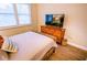 Guest bedroom with queen bed, dresser, and wood floors at 5169 Oxford Dr, Sarasota, FL 34242