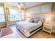 Main bedroom with king-size bed, window seating and wood floors at 5169 Oxford Dr, Sarasota, FL 34242