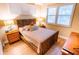 Guest bedroom with a queen bed and wood floors at 5169 Oxford Dr, Sarasota, FL 34242