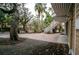 Exterior view showing a brick paver patio, lush landscaping, and exterior staircase at 5169 Oxford Dr, Sarasota, FL 34242