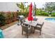 Patio furniture with umbrella near the pool at 5169 Oxford Dr, Sarasota, FL 34242