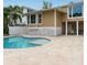 Spacious pool area with beige tile deck at 5169 Oxford Dr, Sarasota, FL 34242