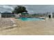 Community pool with lounge chairs and umbrellas at 5169 Oxford Dr, Sarasota, FL 34242