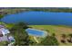 Aerial view of community tennis courts and nearby lake in residential neighborhood at 5171 51St W Ln, Bradenton, FL 34210