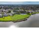 Aerial view of a residential neighborhood with a large lake and community tennis courts at 5171 51St W Ln, Bradenton, FL 34210