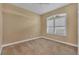 Bedroom with neutral carpet, light walls, and a window with white shutters at 5171 51St W Ln, Bradenton, FL 34210