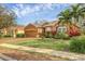 Charming single-story home with well-manicured lawn and brick driveway, lovely landscaping and a beautiful blue sky at 5171 51St W Ln, Bradenton, FL 34210