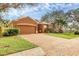 Charming single-story home with well-manicured lawn and brick driveway, lovely landscaping, and a view of the pond at 5171 51St W Ln, Bradenton, FL 34210