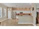 Well-lit kitchen with stainless steel appliances, white cabinetry, and a breakfast bar at 5171 51St W Ln, Bradenton, FL 34210