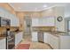 Open kitchen featuring stainless steel appliances, light granite countertops, and white cabinetry at 5171 51St W Ln, Bradenton, FL 34210