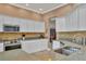 Kitchen featuring stainless steel appliances, tan backsplash, and light granite countertops at 5171 51St W Ln, Bradenton, FL 34210