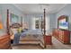 Bedroom with four poster bed, light blue walls, and natural light at 5171 51St W Ln, Bradenton, FL 34210