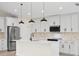 Modern kitchen with white cabinets, quartz countertops, and stainless steel appliances at 5270 Adina Cir, North Port, FL 34291