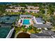 Aerial view of community pool, tennis courts, and clubhouse at 5450 Eagles Point Cir # 301, Sarasota, FL 34231