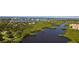 Aerial view of waterfront property with lush landscaping and community at 5450 Eagles Point Cir # 301, Sarasota, FL 34231