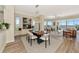 Open concept dining area with modern table and chairs, water views at 5450 Eagles Point Cir # 301, Sarasota, FL 34231