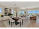 Open concept dining room with modern decor and stunning water views at 5450 Eagles Point Cir # 301, Sarasota, FL 34231