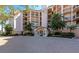 Elegant condo building with a grand entrance and manicured landscaping at 5450 Eagles Point Cir # 301, Sarasota, FL 34231