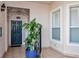 Inviting condo entryway with a dark blue door and lush plants at 5450 Eagles Point Cir # 301, Sarasota, FL 34231