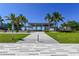 Beach access with paved walkway and shaded seating area at 5855 Midnight Pass Rd # 520, Sarasota, FL 34242