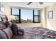 King-size bed with patterned bedding and city views at 5855 Midnight Pass Rd # 520, Sarasota, FL 34242