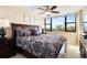 King-size bed, city views, and ceiling fan at 5855 Midnight Pass Rd # 520, Sarasota, FL 34242