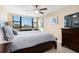 Spacious bedroom with a king-size bed and large window offering city views at 5855 Midnight Pass Rd # 520, Sarasota, FL 34242