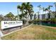 Building entrance with waterfront views and landscaping at 5855 Midnight Pass Rd # 520, Sarasota, FL 34242